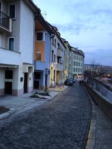 a cobblestone street in a city with buildings at Pleasant apartment under the Bratislava castle in Bratislava