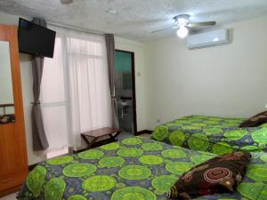 Postel nebo postele na pokoji v ubytování Hotel La Guaria Inn & Suites