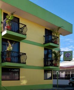 
a building with a bunch of windows on top of it at Hotel La Guaria Inn & Suites in Alajuela
