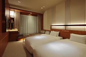 Postel nebo postele na pokoji v ubytování Candeo Hotels Omiya