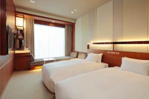 Postel nebo postele na pokoji v ubytování Candeo Hotels Omiya