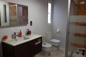 a white bathroom with a toilet and a sink at Kal massis in Pinell de Bray +39 photos