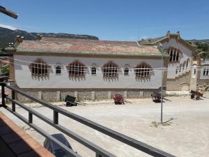 a building with a fence in front of it at Kal massis in Pinell de Bray