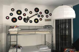 a wall with a bunch of records on a wall at Studio POP DESIGN in Milly-la-Forêt +25 photos