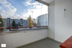 a balcony with a large window with a view of buildings at Next to City Center, Beside Bus and Train Station, Safe and Cozy Place in Oulu