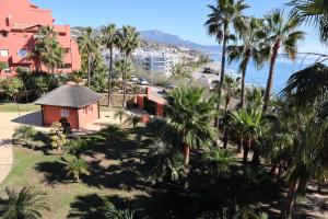 Blick auf ein Resort mit Palmen und das Meer in der Unterkunft Penthouse Luxury Faro Casasol in Torrox Costa
