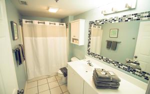 a bathroom with a white sink and a shower at Water Street Retreat 08 in Wilmington +31 photos