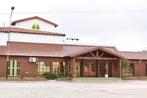 a large brick building with a sign on top of it at Ambientes de la Patagonia in Winifreda