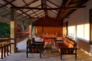 a pavilion with a table and chairs and a dining room at Nice View guest house & restaurant in Ella