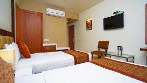 Postel nebo postele na pokoji v ubytování Hotel Pooja Palace
