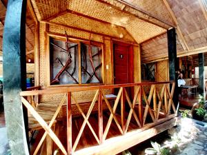 a house with stained glass windows and a staircase at Castaway Native Huts in San Vicente