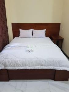 a bed with a pair of shoes sitting on it at iLOMBA in Probolinggo