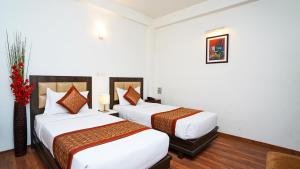 Postel nebo postele na pokoji v ubytování Hotel Pooja Palace