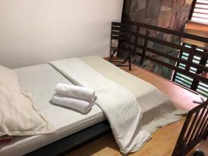 a bed with two towels on it in a room at ESTAR AQUI Bogotá in Bogotá