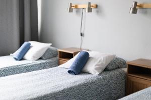 a bed with two pillows and two nightstands at Bed&Breakfast Tuure in Turku