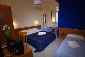 Postel nebo postele na pokoji v ubytování Hotel Merlino