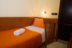 Postel nebo postele na pokoji v ubytování Hotel Merlino