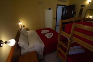 Postel nebo postele na pokoji v ubytování Hotel Merlino