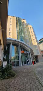 a large building with a brick sidewalk in front of it at MiHotel in Milan