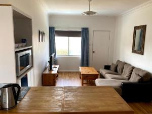 a living room with a couch and a table at Waldeck Heights in Geraldton