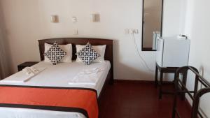 Postelja oz. postelje v sobi nastanitve New SeaSide Inn Hikkaduwa