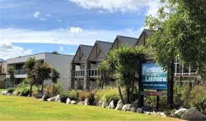 a building with a sign in front of it at Fiordland Lakeview Motel and Apartments in Te Anau