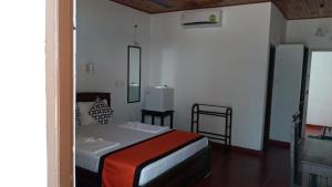Postelja oz. postelje v sobi nastanitve New SeaSide Inn Hikkaduwa