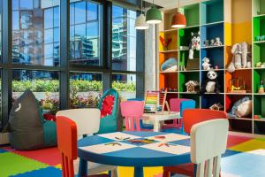 a childrens play area with a table and chairs at Millennium Place Barsha Heights Hotel in Dubai
