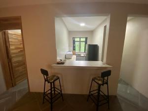 a kitchen with two bar stools and a counter top at KSTUDIOS in Grand Baie