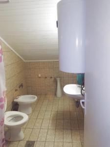 a bathroom with two toilets and a sink at Apartmani Braca2 in Kotor +18 photos