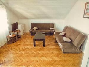 a living room with a couch and a table at Apartmani Braca2 in Kotor