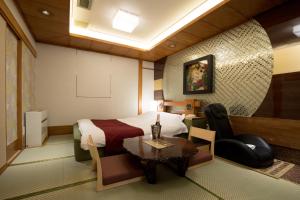 a hotel room with a bed and a table at HOTEL PERRIER (Adult Only) in Tokyo +16 photos