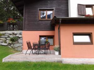 a patio with chairs and a table in front of a house at Haus Julia in Bad Kleinkirchheim