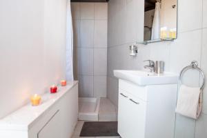 a white bathroom with a sink and a shower at Marmaras in Lyso