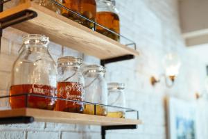 a group of glass bottles on shelves on a wall at Hotel Pacific Kanazawa in Kanazawa