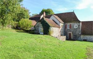 an old stone house on a grassy hill at Cozy Home In Mayrinhac-lentour With Private Swimming Pool, Can Be Inside Or Outside in Mayrinhac-Lentour