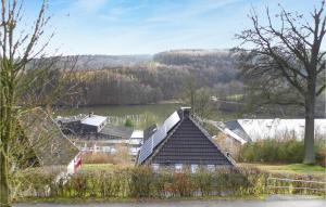 a house with a roof with a river in the background at Ferienhaus 70 In Kirchheim in Kemmerode