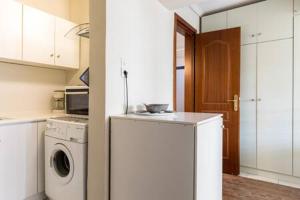 a kitchen with a washing machine and a washer at Irodotou Studio in Thessaloniki