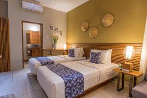 Postel nebo postele na pokoji v ubytování Pangkung Sari Bed and Breakfast