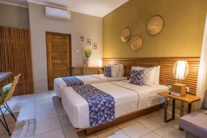Postel nebo postele na pokoji v ubytování Pangkung Sari Bed and Breakfast