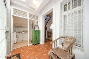 a hallway with a chair and a kitchen in a house at Tainan Travel Inn in Tainan