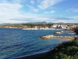 a large body of water with rocks in the water at REZ DE VILLA SIX-FOURS in Six-Fours-les-Plages