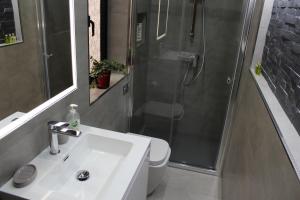 a bathroom with a toilet and a sink and a shower at Cosy Home in Mellieħa +29 photos