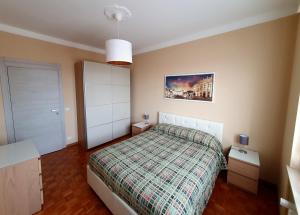 a bedroom with a bed and a picture on the wall at Alloggio Primosole in Fossano