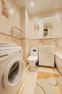 a bathroom with a washing machine and a toilet at ОК! Красноармейская, 151 in Tomsk