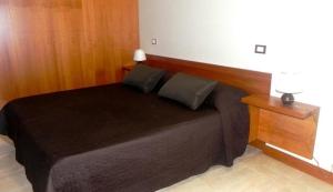 una camera con letto nero e testiera in legno di SAN STAE CASA AURORA a Venezia