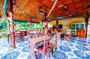 a restaurant with tables and chairs in a room at Venus Resort in Haad Rin