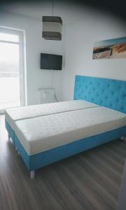 Ένα ή περισσότερα κρεβάτια σε δωμάτιο στο Apartamenty z widokiem na morze