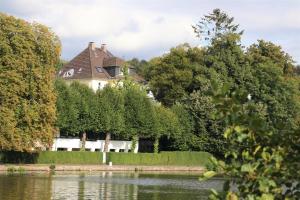 una casa al lado de un lago en Ferienwohnung Villa Ruhr, en Mülheim an der Ruhr