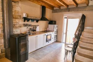 a kitchen with a sink and a stove at Las Postas del Perionda in Calzada de los Molinos